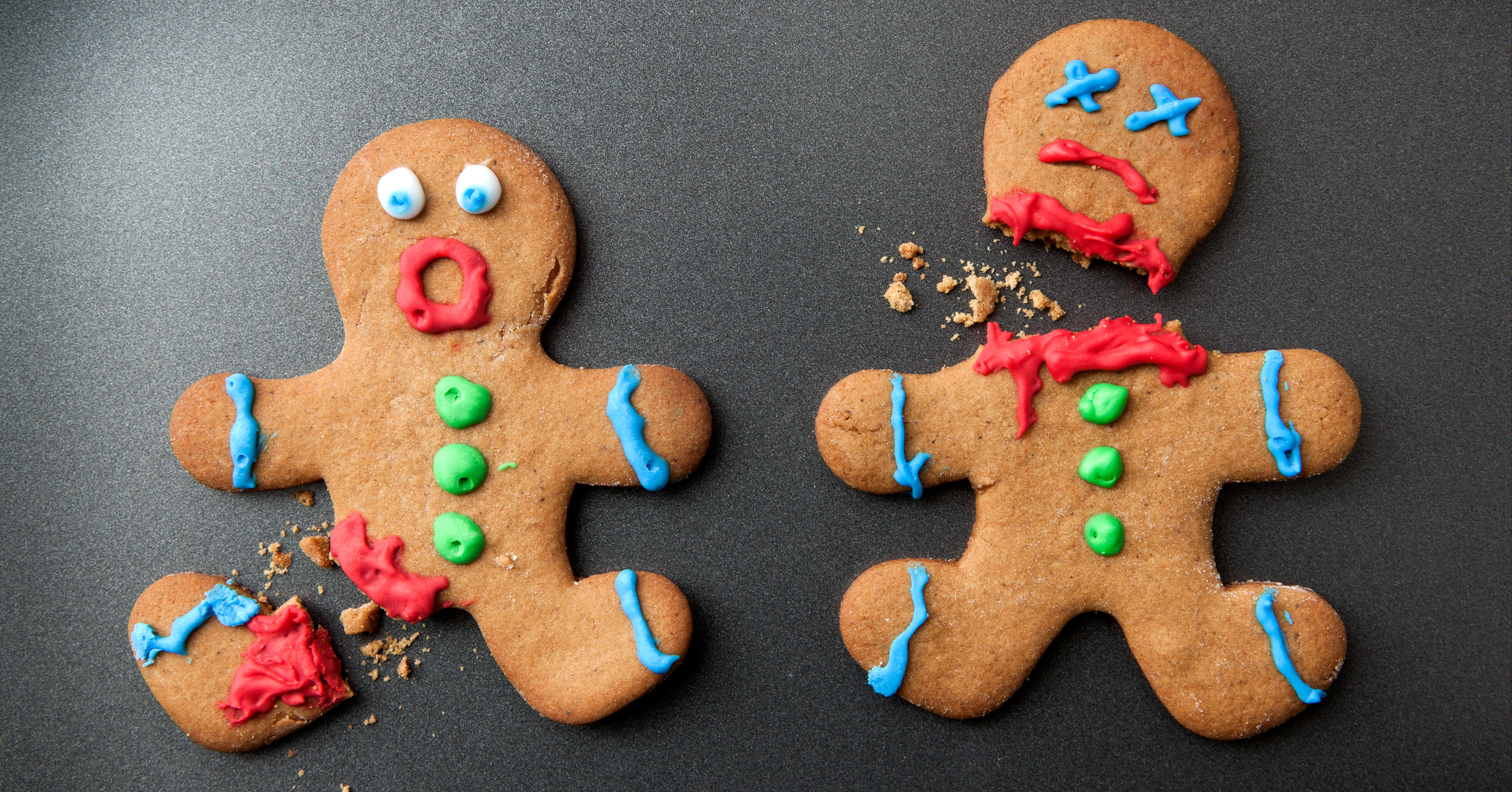 Decapitated gingerbread cookie next to shocked gingerbread cookie